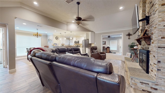 2010 Wildwood Dr, Deer Park, TX 77536 - living area with ceiling fan, a stone fireplace, lofted ceiling, light wood-style floors, and ornamental molding
