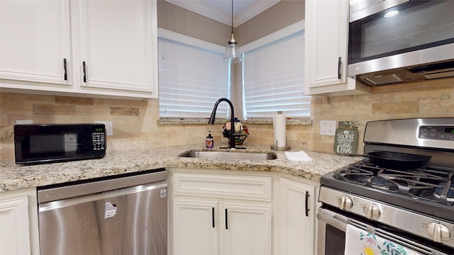 2010 Wildwood Dr, Deer Park, TX 77536 - kitchen with stainless steel appliances, white cabinetry, decorative backsplash, light stone counters, and crown molding