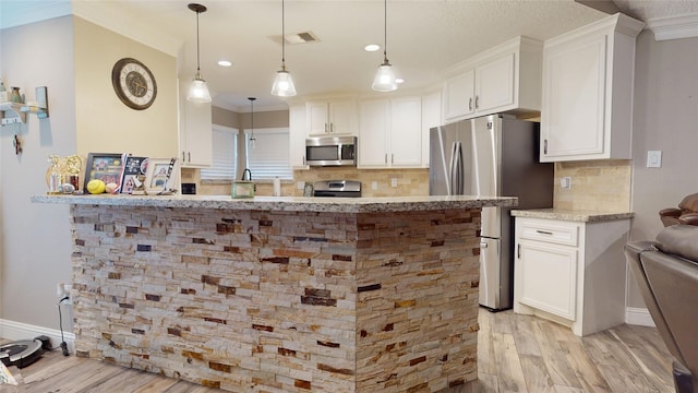 2010 Wildwood Dr, Deer Park, TX 77536 - kitchen with stainless steel appliances, light wood-style floors, white cabinets, light stone counters, and backsplash