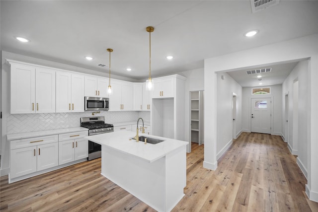 19219 Hikers Trail Dr, Humble, TX 77346 - kitchen featuring stainless steel appliances, decorative backsplash, light countertops, white cabinetry, and recessed lighting