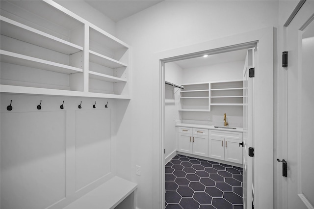 19219 Hikers Trail Dr, Humble, TX 77346 - mudroom featuring dark tile patterned floors and bar with sink