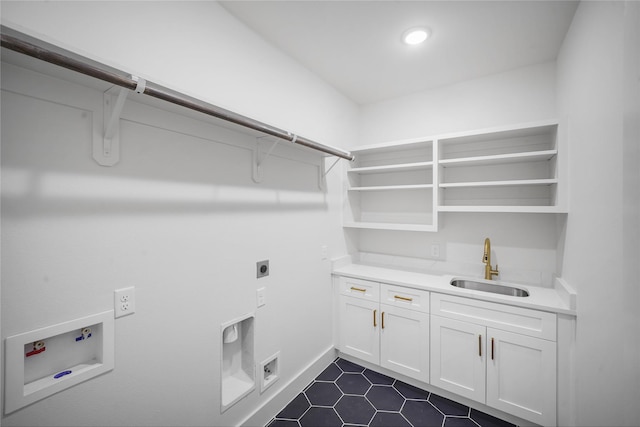 19219 Hikers Trail Dr, Humble, TX 77346 - washroom with hookup for an electric dryer, cabinet space, washer hookup, and dark tile patterned flooring