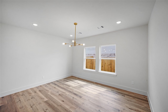 19219 Hikers Trail Dr, Humble, TX 77346 - empty room featuring a chandelier, wood finished floors, and recessed lighting