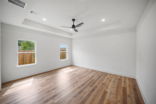 19219 Hikers Trail Dr, Humble, TX 77346 - unfurnished room featuring a tray ceiling, recessed lighting, light wood-style flooring, and a ceiling fan