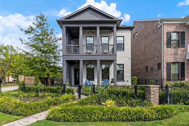 152 E Shell Port Sq, The Woodlands, TX 77380 - view of front of house featuring a balcony, a fenced front yard, a ceiling fan, and brick siding