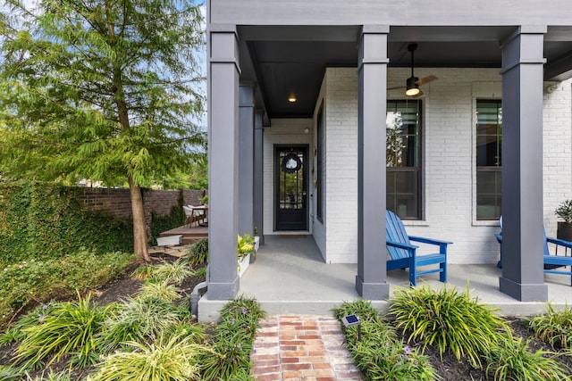 152 E Shell Port Sq, The Woodlands, TX 77380 - doorway to property with covered porch, brick siding, and a ceiling fan