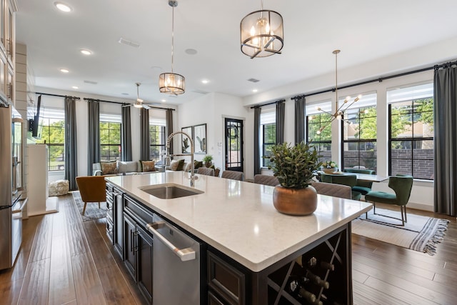 152 E Shell Port Sq, The Woodlands, TX 77380 - kitchen with stainless steel appliances, a chandelier, open floor plan, dark wood-style flooring, and recessed lighting