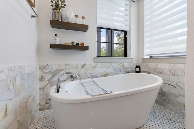 152 E Shell Port Sq, The Woodlands, TX 77380 - bathroom with a freestanding bath, tile walls, and a wainscoted wall