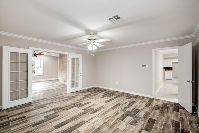 13903 Chevy Chase Dr, Houston, TX 77077 - spare room featuring ceiling fan, french doors, ornamental molding, and wood finished floors