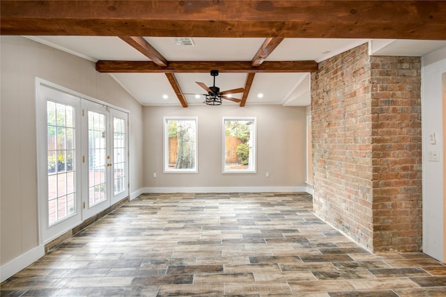 13903 Chevy Chase Dr, Houston, TX 77077 - unfurnished dining area featuring plenty of natural light, ceiling fan, beamed ceiling, wood finished floors, and brick wall