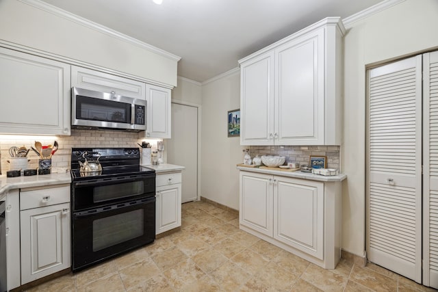 5001 Woodway Dr Unit 1701, Houston, TX 77056 - kitchen featuring range with two ovens, stainless steel microwave, decorative backsplash, light countertops, and ornamental molding