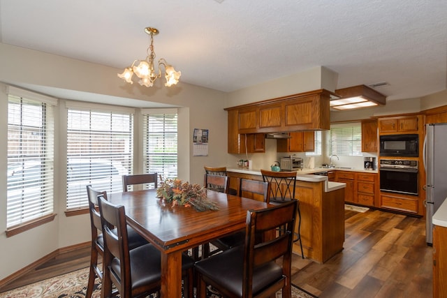 3701 Regency Dr, Deer Park, TX 77536 - dining room featuring a chandelier and dark wood-style floors
