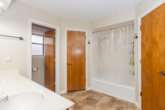 3701 Regency Dr, Deer Park, TX 77536 - full bath with double vanity, shower / bath combination with curtain, and stone finish flooring