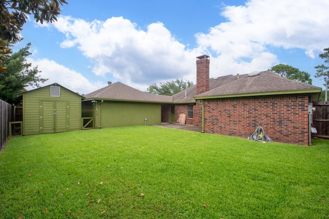 3701 Regency Dr, Deer Park, TX 77536 - back of house featuring a fenced backyard, a storage unit, a chimney, a shingled roof, and a patio