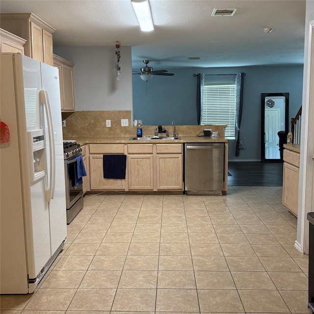 3619 Robwood Ct, Katy, TX 77449 - kitchen featuring appliances with stainless steel finishes, ceiling fan, light tile patterned floors, a peninsula, and light countertops