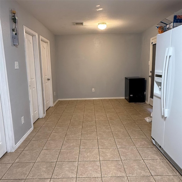 3619 Robwood Ct, Katy, TX 77449 - kitchen with white fridge with ice dispenser and light tile patterned flooring