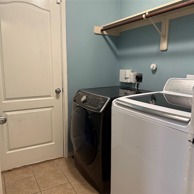 3619 Robwood Ct, Katy, TX 77449 - washroom featuring washing machine and clothes dryer and light tile patterned flooring