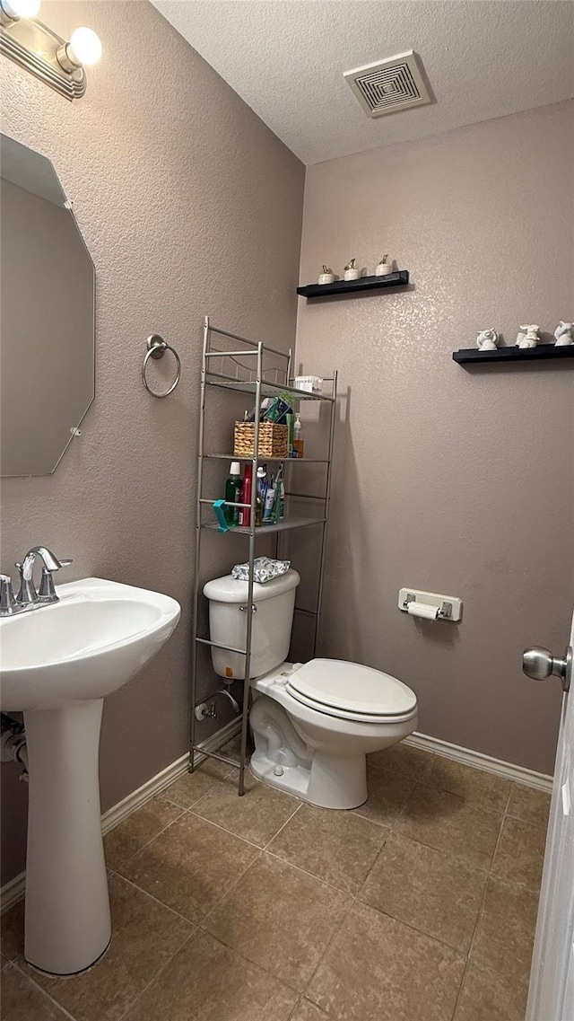 3619 Robwood Ct, Katy, TX 77449 - half bathroom with tile patterned floors and a textured ceiling