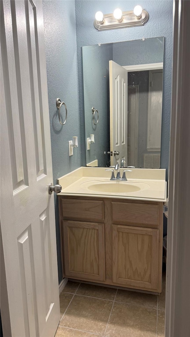 3619 Robwood Ct, Katy, TX 77449 - bathroom featuring vanity, a textured wall, and tile patterned floors