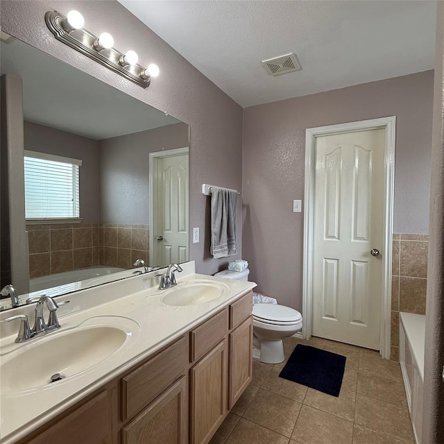 3619 Robwood Ct, Katy, TX 77449 - full bath with a garden tub, double vanity, tile patterned flooring, a textured wall, and a textured ceiling