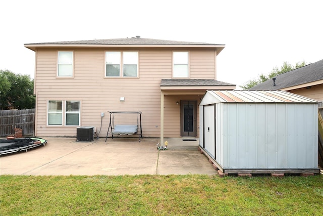 3619 Robwood Ct, Katy, TX 77449 - back of property featuring a shed, a trampoline, a patio, and board and batten siding