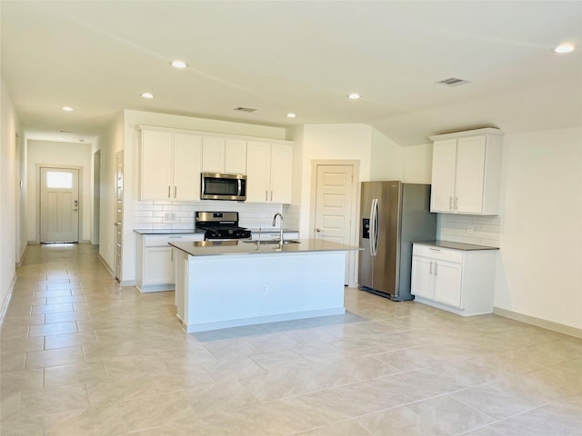 4107 Yosemite Valley Ct, Katy, TX 77494 - kitchen with appliances with stainless steel finishes, decorative backsplash, recessed lighting, a kitchen island with sink, and white cabinets