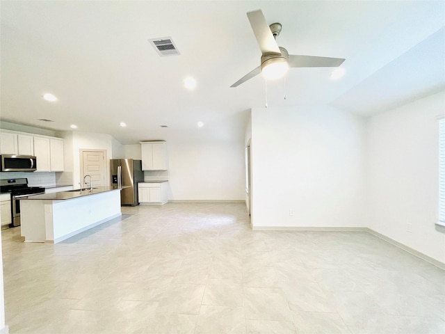 4107 Yosemite Valley Ct, Katy, TX 77494 - kitchen with stainless steel appliances, open floor plan, a ceiling fan, recessed lighting, and white cabinets