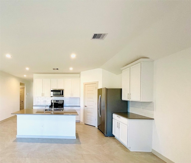 4107 Yosemite Valley Ct, Katy, TX 77494 - kitchen with appliances with stainless steel finishes, tasteful backsplash, recessed lighting, and white cabinetry