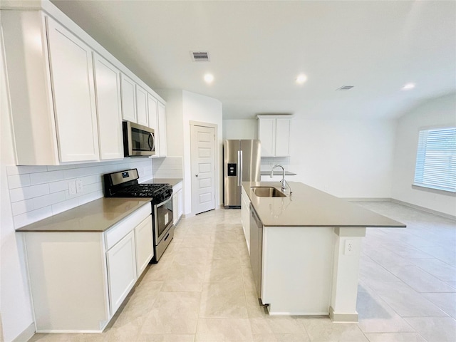 4107 Yosemite Valley Ct, Katy, TX 77494 - kitchen with stainless steel appliances, backsplash, an island with sink, recessed lighting, and white cabinets