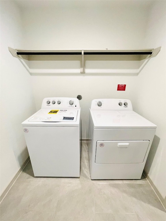 4107 Yosemite Valley Ct, Katy, TX 77494 - laundry room featuring washer and dryer and light tile patterned floors