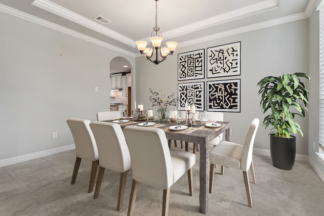 6510 Brady Springs Ct, Sugar Land, TX 77479 - dining space featuring a tray ceiling, a chandelier, ornamental molding, arched walkways, and light tile patterned flooring