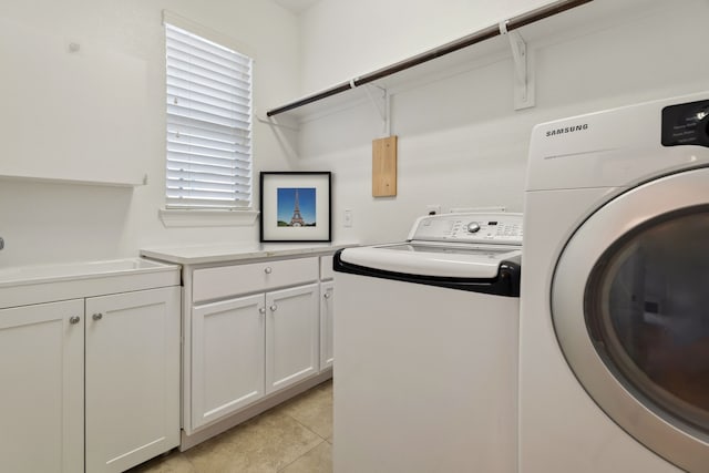 6510 Brady Springs Ct, Sugar Land, TX 77479 - laundry area with washer and dryer, cabinet space, and light tile patterned flooring