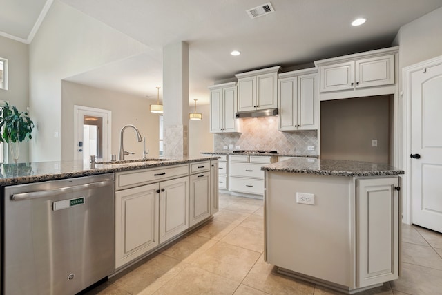 6510 Brady Springs Ct, Sugar Land, TX 77479 - kitchen with appliances with stainless steel finishes, a kitchen island, decorative backsplash, dark stone countertops, and light tile patterned floors