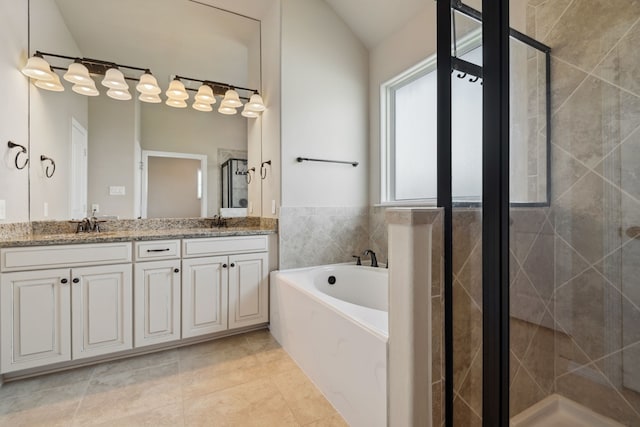 6510 Brady Springs Ct, Sugar Land, TX 77479 - full bath featuring double vanity, a bath, a shower stall, tile patterned flooring, and vaulted ceiling
