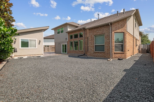 6510 Brady Springs Ct, Sugar Land, TX 77479 - rear view of house with brick siding and a shingled roof