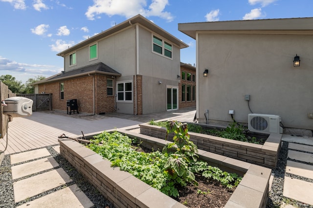 6510 Brady Springs Ct, Sugar Land, TX 77479 - rear view of house with a wooden deck, stucco siding, and brick siding
