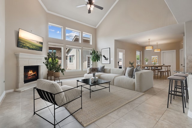 6510 Brady Springs Ct, Sugar Land, TX 77479 - living area featuring a ceiling fan, high vaulted ceiling, ornamental molding, light tile patterned floors, and a warm lit fireplace