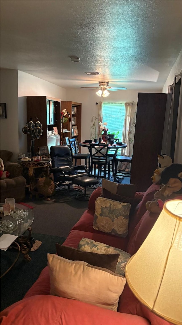 5510 Chennault Rd, Houston, TX 77033 - living room featuring a ceiling fan, a textured ceiling, and carpet flooring