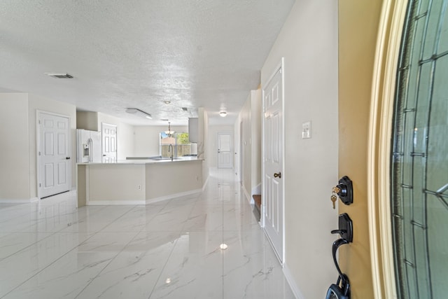 1022 Vera Cruz Dr, Rosenberg, TX 77471 - entrance foyer with a textured ceiling and light marble finish flooring