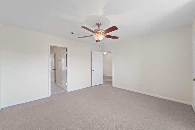 1022 Vera Cruz Dr, Rosenberg, TX 77471 - unfurnished bedroom with light colored carpet, a ceiling fan, and ensuite bathroom