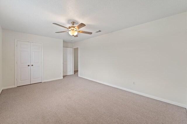 1022 Vera Cruz Dr, Rosenberg, TX 77471 - unfurnished bedroom featuring light colored carpet, a closet, and ceiling fan