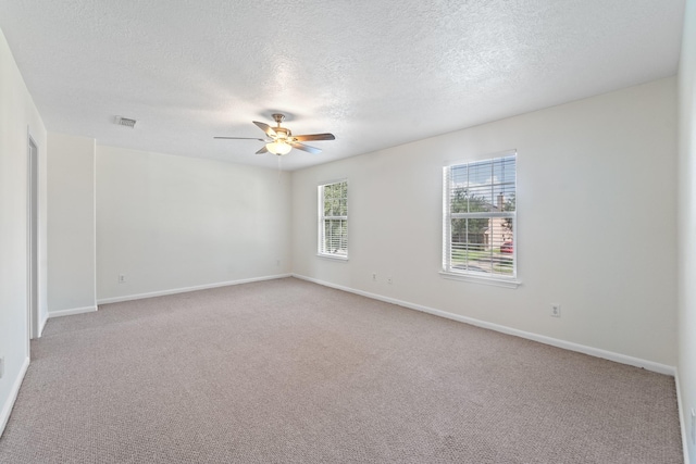 1022 Vera Cruz Dr, Rosenberg, TX 77471 - spare room featuring ceiling fan, a textured ceiling, and light colored carpet
