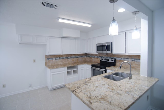 6503 Gladewell Dr, Houston, TX 77072 - kitchen featuring stainless steel appliances, a peninsula, white cabinetry, and light stone countertops