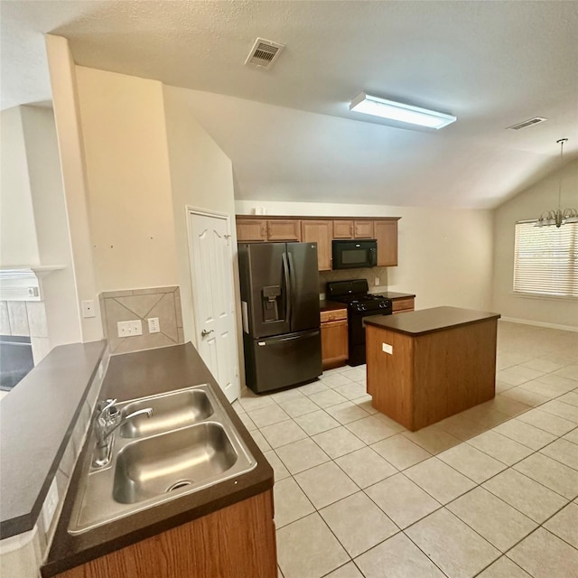 1005 Summer Park Blvd, Conroe, TX 77303 - kitchen featuring black appliances, lofted ceiling, dark countertops, light tile patterned floors, and a kitchen island