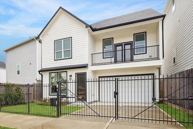 1825 Northwood Dr, Houston, TX 77009 - view of front of property featuring a balcony, an attached garage, concrete driveway, a fenced front yard, and a shingled roof