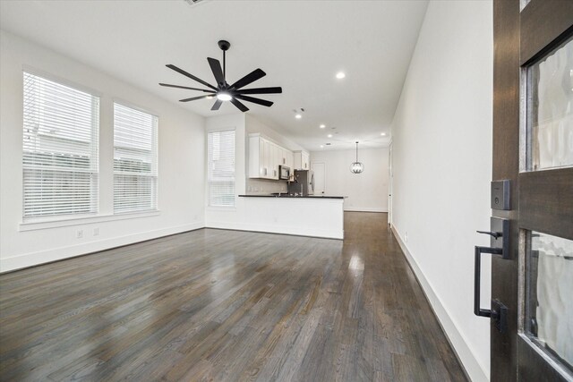 1825 Northwood Dr, Houston, TX 77009 - unfurnished living room featuring ceiling fan, dark wood-style floors, and recessed lighting