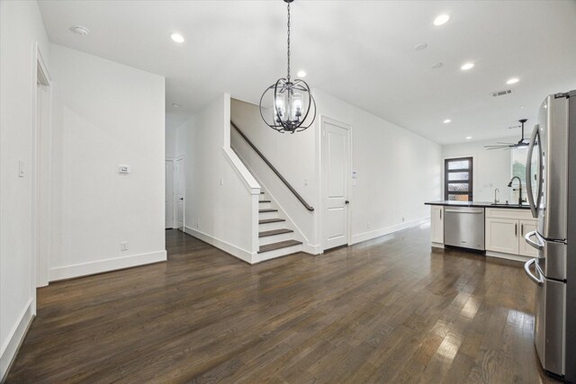 1825 Northwood Dr, Houston, TX 77009 - unfurnished living room with dark wood-style flooring, stairs, a chandelier, recessed lighting, and ceiling fan