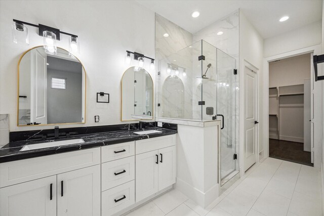 1825 Northwood Dr, Houston, TX 77009 - full bathroom featuring double vanity, a stall shower, a spacious closet, and recessed lighting