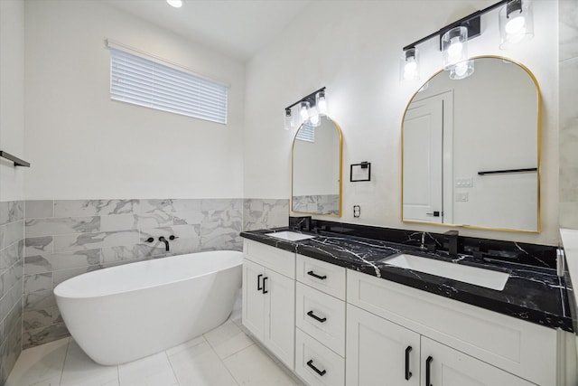 1825 Northwood Dr, Houston, TX 77009 - full bathroom featuring double vanity, tile walls, a soaking tub, and wainscoting