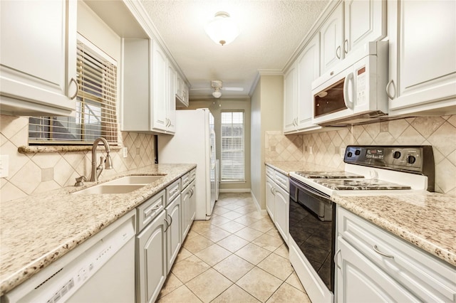 12550 Whittington Dr Unit 816, Houston, TX 77077 - kitchen with white appliances, white cabinetry, a textured ceiling, ornamental molding, and decorative backsplash